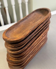 a stack of wooden trays sitting on top of a table