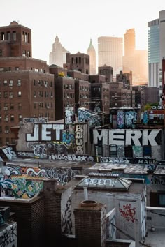 the city skyline is covered in graffiti, including tall buildings and large billboards that read let merk