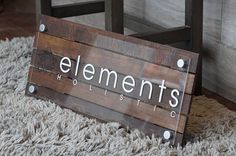 a wooden sign sitting on top of a rug