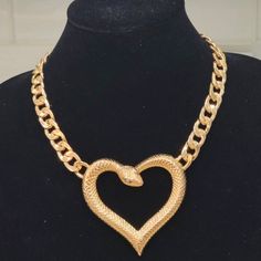 This Uniquely Designed Heart-Shaped Snake Necklace Is Sure To Get The Conversation Started! Goldplated Metal Heart-Shaped Snake With Stone Embellished Eyes. Heavy Duty And Durable Attached Chain. Lobster Claw Clasp. Nice Weight Necklace Size: Approximately 18.5 Inches In Length. Extender Pendant: Approximately 3 X 3 Inches Metal Heart Necklace For Party, Gold Open Heart Necklace For Party, Gold-tone Metal Heart Necklace, Gold-tone Heart-shaped Metal Necklace, Gold-tone Heart Shaped Metal Necklace, Snake Pendant, How To Start Conversations, Snake Necklace, Metal Heart