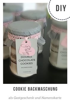 cookies in jars with tags on them sitting on a table next to the words, double chocolate cookies