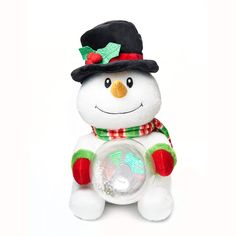 a white snowman with a green and red scarf on it's head sitting