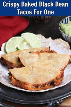 crispy baked black bean tacos for one on a plate with lime wedges