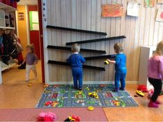 two children playing with toys in a playroom