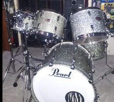 a pair of silver sparkle drums sitting on top of a floor