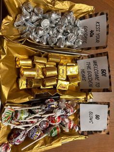 two boxes filled with candy and wrapped in gold foil