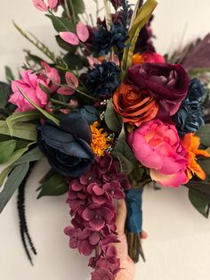 a person holding a bouquet of flowers in their hand