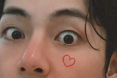 a woman with a heart drawn on her nose