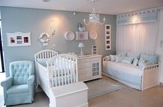 a baby's room with blue and white furniture