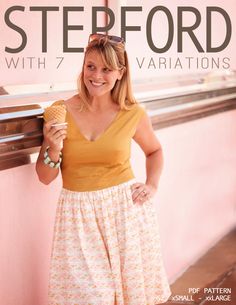 a woman standing next to a pink wall holding an ice cream cone in her hand