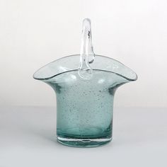 a glass vase with a handle on it