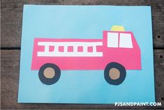 a paper cut out of a pink firetruck on a blue and brown background