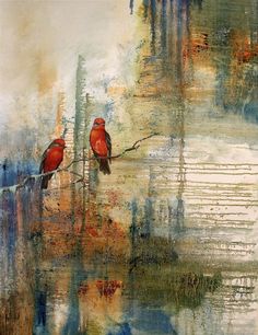 two red birds sitting on top of a tree branch