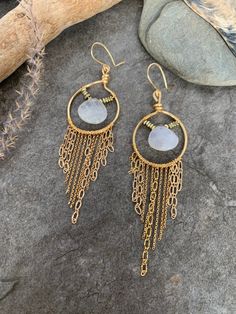 Fun boho style fringe earrings ... crafted with hand forged gold tone hoops with hand wire wrapped dainty gold tone chain accented with elegant Moonstone focal gemstones . These beauties measure 4 inches in length . Bohemian Gold Hoop Earrings With Dangling Charms, Bohemian Gold Earrings With Dangling Charms, Gold Bohemian Jewelry With Dangling Charms, Bohemian Dangle Hoop Earrings In 14k Gold Filled, Bohemian Wire Wrapped Long Drop Jewelry, Bohemian 14k Gold Filled Dangle Hoop Earrings, Bohemian Long Drop Wire Wrapped Jewelry, Bohemian Moonstone Earrings, Gold Wire Wrapped Chandelier Earrings