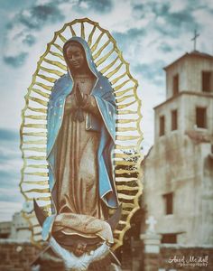 a statue of the virgin mary in front of a building