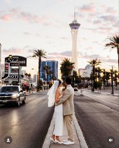 a bride and groom kissing on the street in las vegas