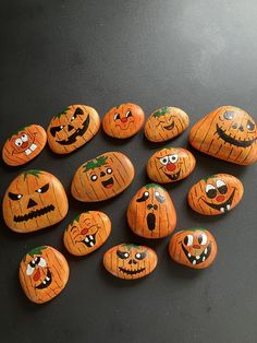 pumpkins painted on rocks with eyes and mouths are arranged in the shape of jack - o'- lanterns