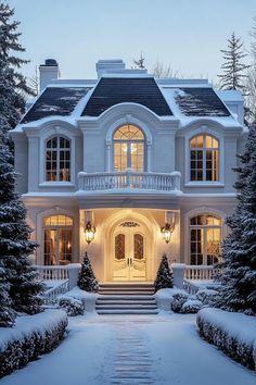 a large white house with snow on the ground