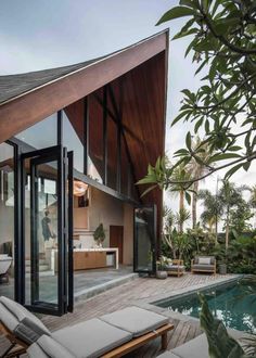 an outdoor living area with a pool and patio furniture next to the house's swimming pool