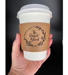 a hand holding a coffee cup that says the perfect blend