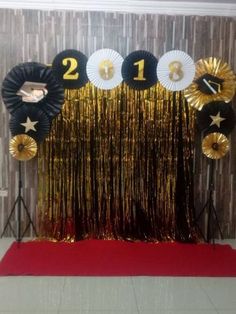 new year decorations in gold and black on a red carpeted area with white walls