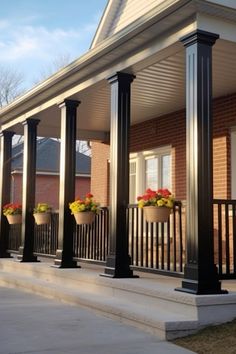 the front porch is decorated with flowers and potted planters on it's pillars