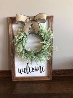 a wooden sign with a wreath on it