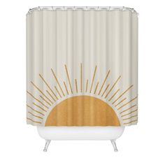 a white shower curtain with gold sunbursts on it