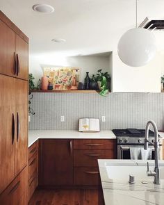 a kitchen with wooden cabinets and white counter tops