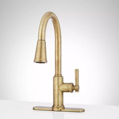 an antique brass faucet on a white countertop with the light turned on