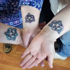 two people with matching tattoos on their arms