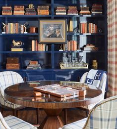 a dining room with blue bookcases and chairs