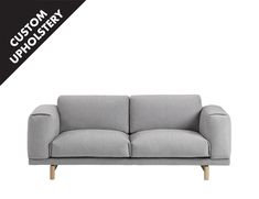 a gray couch with the words custom upholstery on it's side