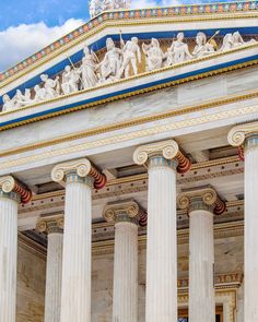 columns and statues on the side of a building