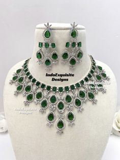 American Diamond Necklace Set / CZ Necklace/Indian Jewelry/ Reception Jewelry/ Bollywood Jewelry/ Silver Green All items are shipped from Brampton, Ontario, Canada. If you need your item by a certain day, please reach out to us for express delivery option before placing the order so that we can update the shipping for you. Standard shipping/delivery timeline Below are the delivery timeline estimates. We dispatch all orders by the next business day. ---> USA delivery timeline * 4-8 business days to major urban centers in USA. It may take 2-3 days extra to remote locations ---> Canada delivery timeline  * 2-3 business days - GTA  & Montreal  * 2-4  business days - Rest of Ontario/Quebec * 4-8 business days-  Rest of Canada    ---> Europe/Middle East timeline * 5-10 business days We kindly re Formal Silver Jewelry Sets With Emerald, Formal Silver Emerald Jewelry Sets, Silver Emerald Jeweled Necklace For Anniversary, Elegant Silver Necklace With Emerald For Party, Formal Silver Hallmarked Emerald Necklace, Green Hallmarked Emerald Necklace For Wedding, Elegant Silver Emerald Necklace For Party, Silver Diamond Necklace With Jewels For Wedding, Party Bridal Necklace With 17 Jewels In Sterling Silver