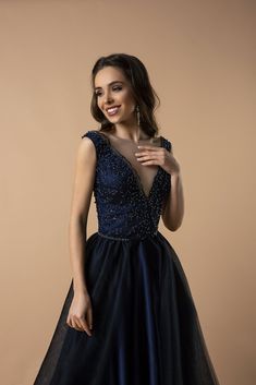 Discover the epitome of evening sophistication with our Regal Navy Sequin-Embroidered A-Line Gown. This dress combines luxurious detailing with an aura of timeless grace. The bodice, adorned with intricate sequin embroidery, creates a mesmerizing pattern that sparkles with every movement. Crafted to flatter, the plunging V-neckline adds a touch of allure, while the sheer overlay introduces a dreamy and romantic silhouette. Embracing a plus-size fit, this gown ensures comfort without compromising V-neck Tulle Ball Gown For Formal Occasions, Glamorous Tulle Gown With V-neck, Formal V-neck Gown With Illusion Neckline, Glamorous V-neck Evening Dress With Sheer Bodice, Glamorous Evening Dress With Sheer Bodice And V-neck, V-neck Evening Dress With Sheer Bodice For Gala, Sheer Bodice V-neck Evening Dress For Gala, V-neck Tulle Ball Gown For Evening, Evening V-neck Tulle Ball Gown