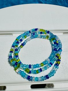 Set of 3  7 inch seed bead bracelets. The colors are random but there will never be more than 3 of the same color in a row. This bracelet will come with a random pattern of the bead colors in the pictures. These beads are very good quality and will last if taken care of properly.  All jewelry is made with elastic stretchy cord so you can roll on with ease. note all jewelry is nonrefundable since it is made custom with love for you :) ANY QUESTIONS AT ALL PLEASE DON'T HESITATE TO MESSAGE ME I WILL GET BACK TO YOU ASAP! * Please roll on bracelets to avoid over-stretching. * wrap and roll gently * As with any bead that is not a precious metal you should not expose your bracelets to water or direct sun also natural body oils, lotions, and other materials could cause discoloration. *Each bracel Heishi Beads Multi-strand Bracelets For Beach, Adjustable Multi-strand Beaded Bracelets For Summer, Beach Multi-strand Colorful Beaded Bracelets, Colorful Multi-strand Beaded Bracelets For Beach, Summer Beach Friendship Bracelets With Spacer Beads, Summer Beaded Multi-strand Bracelets, Bohemian Blue Hypoallergenic Beaded Bracelets, Hypoallergenic Beaded Bracelets For Summer, Multi-strand Colorful Beads Friendship Bracelets For Beach