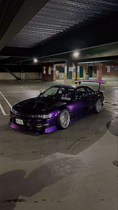 a purple car parked in a parking garage