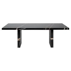 a black marble dining table with metal legs and an intricate design on the top, against a white background