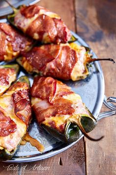 bacon wrapped jalapenos are on a plate