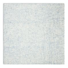 a white rug with blue dots on the top and bottom, against a white background