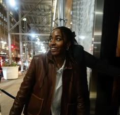 a woman with dreadlocks walking down the street