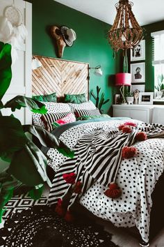 an instagram photo of a bedroom with green walls and black and white bedding