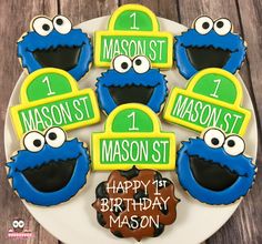 decorated cookies on a plate with the words happy 1st birthday mason