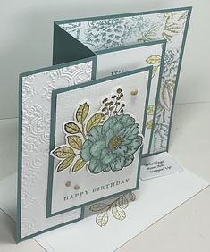 two cards with flowers on them, one is blue and the other has green leaves