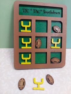 a wooden board with magnets on it sitting next to some other items that are in the shape of numbers