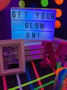 the neon sign is lit up and it says get your glow on