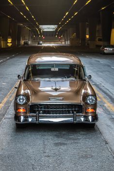 an old car parked in the middle of a tunnel