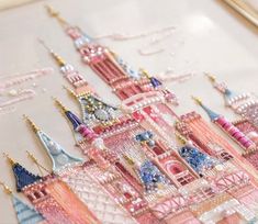 a close up of a castle made out of bead and beads on a piece of cloth