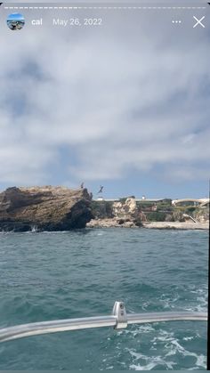 the ocean is clear and blue with some clouds in the sky, while people are swimming